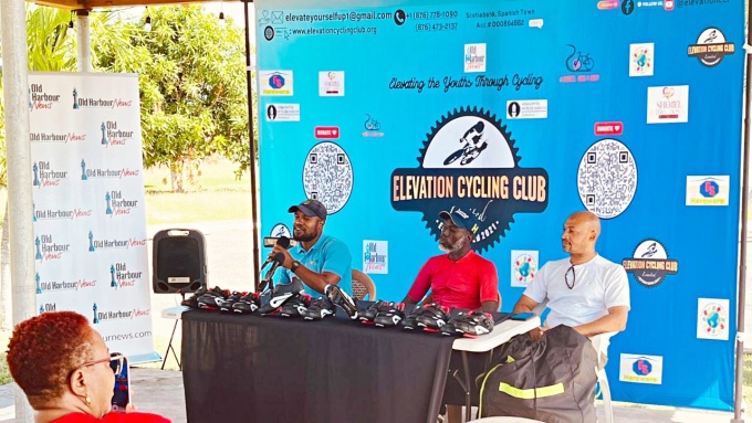 Jamaica Cycling Federation First Vice President Kamar Jordan (left) addresses the gathering, while looking on are Merrington Hall (centre), founder of One Piece Cycling Club and Kevin Dillon of Dillies Cycle World 