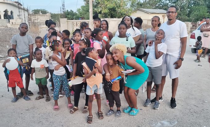 Duwayne Newman (right back row) shares in a photo-op with the children of Lloyd’s Pen. 