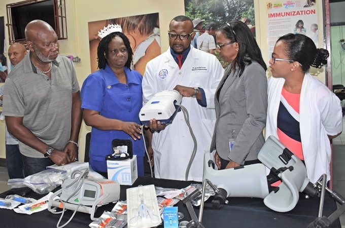 Dr. Garth McDonald (centre), senior medical officer, Victoria Jubilee Hospital demonstrates how the attachment of the deep vein thrombosis (DVT) pump works. Looking on are (L-R) Bruce Palmer, president, JURA; Elise Fairweather Blackwood, director of nursing services, VJH; Kathleen Cooper-Brown, acting CEO, Kingston Public and Victoria Jubilee Hospital and Dr. Yanique Brown, consultant, neonatal care unit, VJH.(Photo: Contributed)
