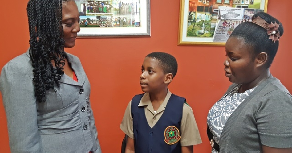 Josephine Parker-Mullings (left), acting principal, Marlie Mount Primary and Infant School in discussion with Amir Stewat (centre) and class teacher Tameka Hall-Campbell. (OH News Photo)