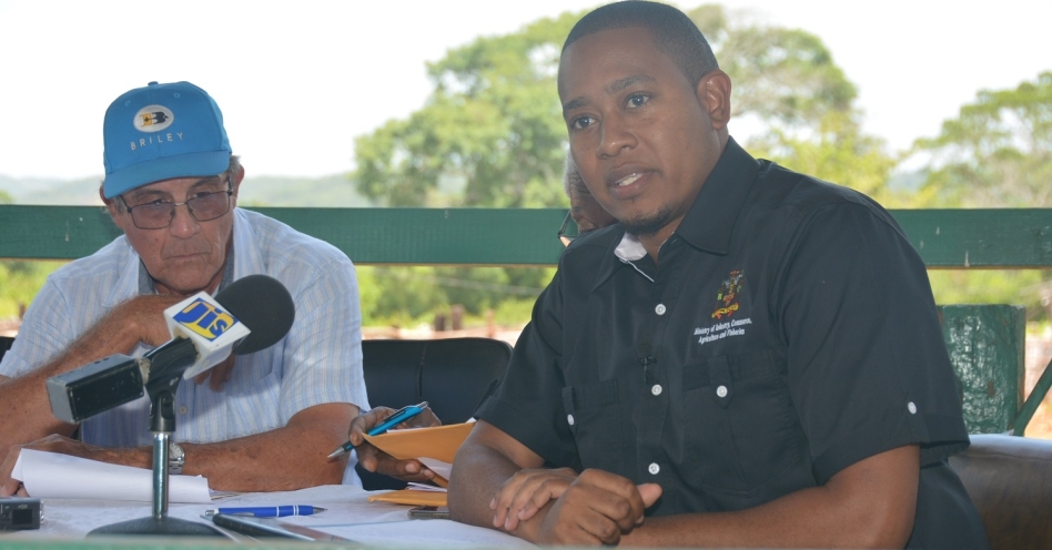 Minister of State in the Ministry of Industry, Commerce, Agriculture and Fisheries, Hon. Floyd Green (right), speaks at the joint Annual General Meeting (AGM) of the Jamaica Red Poll and Jamaica Black Cattle Breeders Societies, at Minard Estate in Brown’s Town, St Ann, on July 17. Listening (at left) is President of the Red Poll Cattle Breeders’ Society, Martin Hopwood. (JIS Photo)