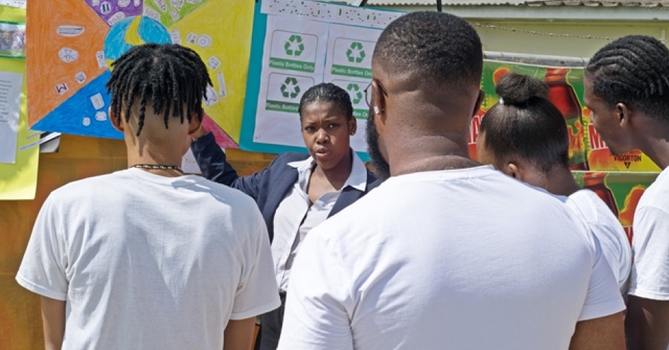 Lydia Kelly speaks to her team about proper garbage recycle management its effects on climate change. (Photo: Michael Caballero)