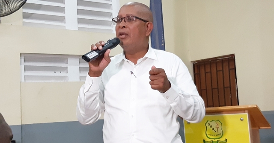 Mayor Norman Scott speaking at the town hall meeting at Old Harbour High School on February 26