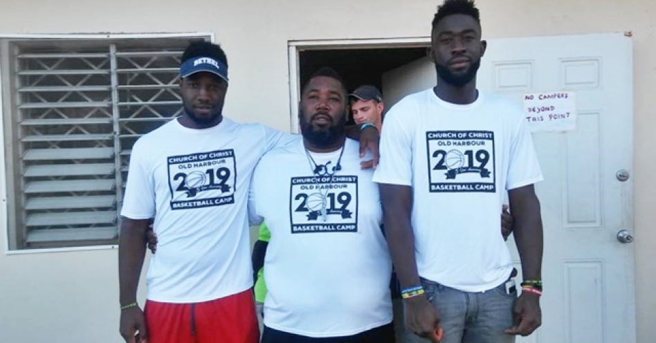 Nicoloy Bailey (left), coach Ricardo Edwards and Javel Redwood share lens time during the recent Old Harbour Church of Christ Basketball Camp. (Photo: Avery Benter)
