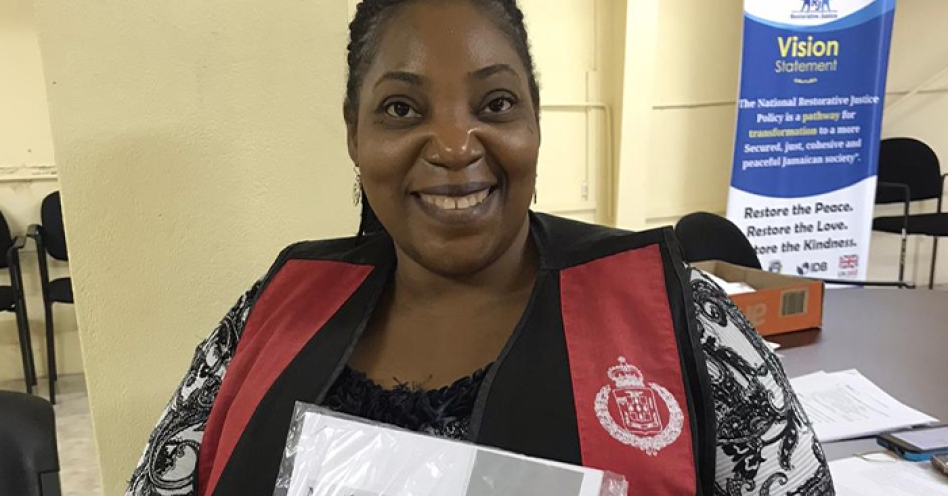 Detective Inspector of Police Pilmar Powell displays one of the packages being distributed to students in the Kingston Western Police Division under the academic support initiative.