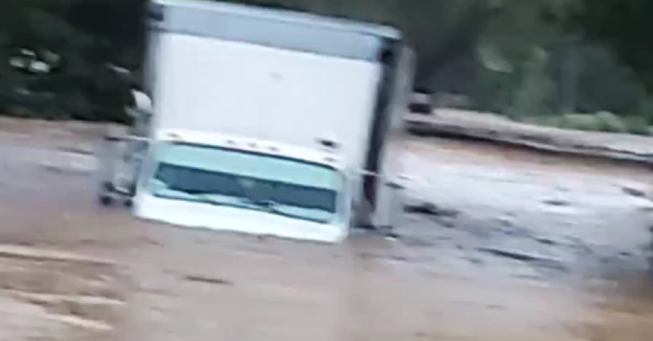 A truck trapped in flood waters at Rasta Corner in Freetown, Clarendon