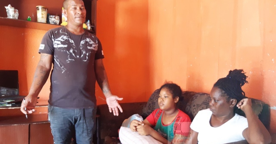 Clovis Williams (left) says he is not a happy man since his daughter Selena (centre) was diagnosed with lupus, while his wife Merdylin stares into oblivion during an interview with Old Harbour News at their Burkesfield home in Old Harbour Bay, St Catherine. (OH News Photo)