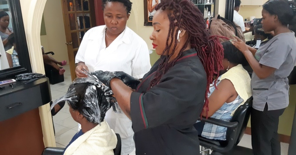 Treacha Reid-McCalla (right) attends to one of the girls from Yadel Home for Girls at Shades of Elegance (OH News Photo)