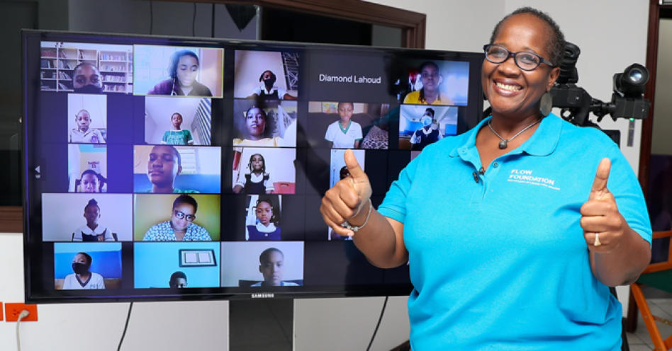 Shelly-Ann O’Connor, operations and projects coordinator at the Flow Foundation shares a photo op moment with participants in Flow’s SID ‘Kids’ Table Talk pre-teen online safety session covering safe internet practices and how to avoid cyber bullying. (Contributed Photo)