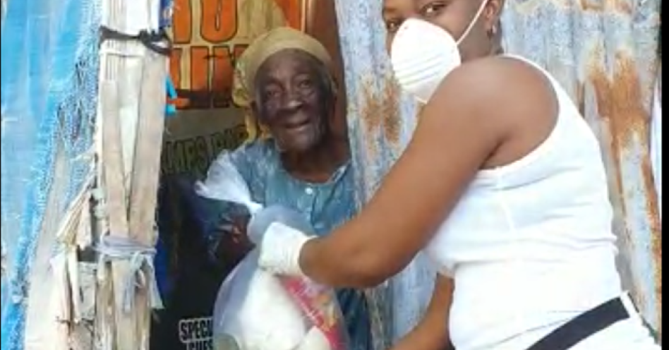 A staff member of Stress Free Grocery and Meat delivers a care package to resident of Hope Bay, Portland