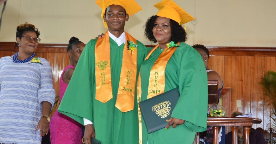 Aneshia Brown (right), and her son, Orlando Barrett, at the 50th Grange Hill High School graduation ceremony held on February 20 at the Grange Hill New Testament Church of God in Westmoreland. The mother and son participated in the National Unattached Youth Programme (NUYP) offered at the school. (JIS Photo)