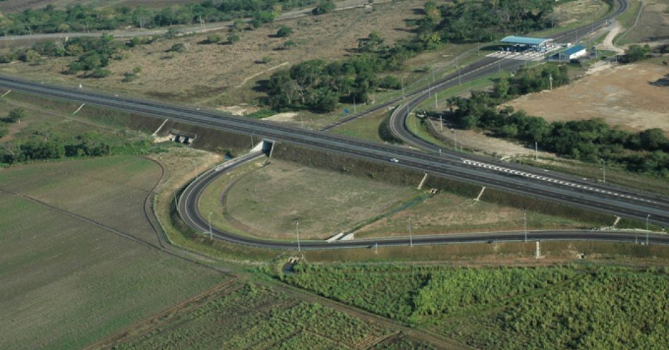 An aerial view of the East West Toll Road and the Spanish Town Toll Plaza along Highway 2000.