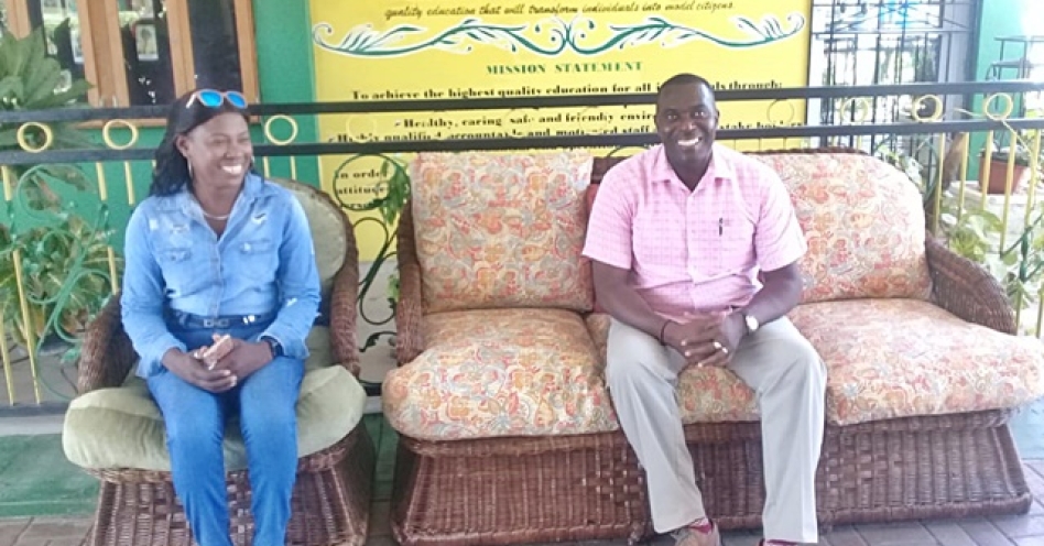 Curdell Hall (left) sits with Lynton Weir, principal, Old Harbour High School following the presentation on August 30, 2019. (Photo: Contributed)